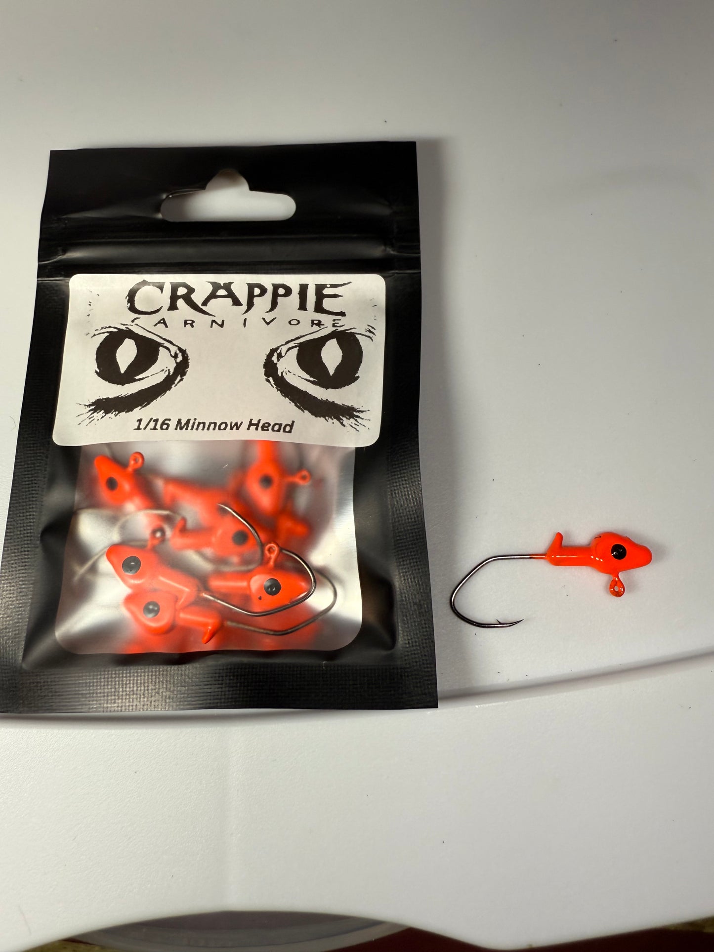 Minnow Jig Head 10/Pack in Blaze Orange color, 1/16oz with sickle style #2 hook, ideal for fishing.